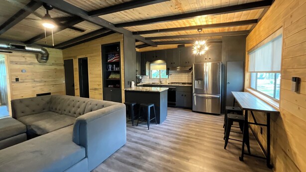 A modern kitchen with a central island, stainless steel appliances, and a wooden ceiling. - Gibson Getaway- Relax and Unwind (Wagoner)