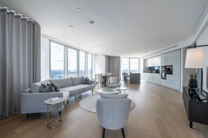 Relax in a spacious living area with a sofa, armchair, and coffee table, perfect for reading or socializing.