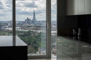 Enjoy a city view from the kitchen window, overlooking a prominent skyscraper and the river.