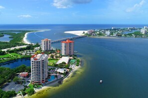 A coastal hotel with multiple high-rise buildings, a marina, and a beach. - Lovers Key Resort 1201 (Fort Myers Beach)