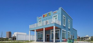 A two-story building with a blue exterior, a sign for 'Pete's Donuts', and a visible entrance.