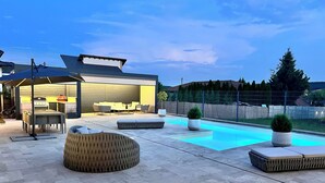 A backyard with a swimming pool, outdoor furniture, and a barbecue area. - Amazing 3 bedroom villa with outdoor pool next to Budapest (Isaszeg)