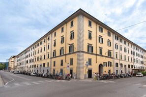 A multi-story building with a row of windows on the ground floor, likely a hotel or apartment complex.