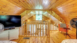 A wooden interior with a TV, fan, and staircase. - Greers Ferry Home w/ Fire Pit Near Shiloh Marina! (Greers Ferry)