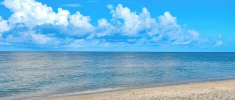 A beach with clear skies and calm water.