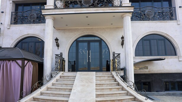 A grand entrance with a marble staircase leading to a large arched doorway, flanked by ornate metal railings and a canopy. - Ketrin Hotel & Restaurant (Masis)