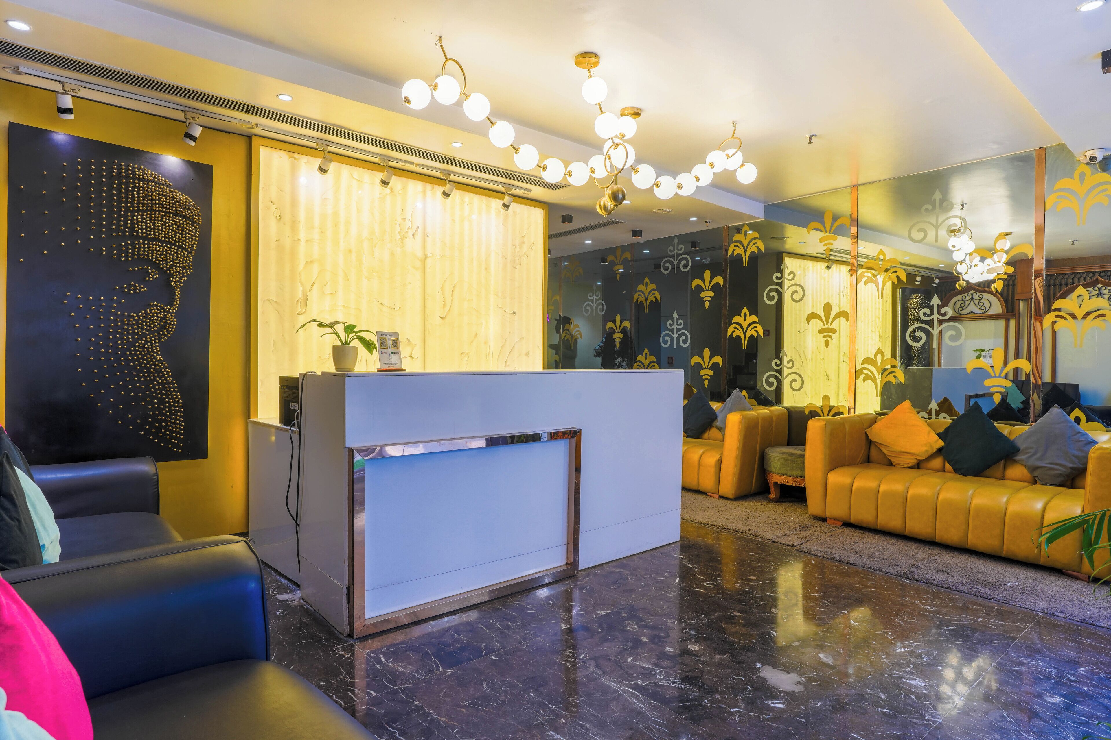 A modern lobby with a reception desk, seating area, and decorative wall art.