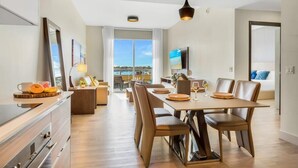 A modern kitchen with a dining area, large windows, and a view of the city. - Apartment w/amazing pool - Front Bay View Terrace (Hollywood)