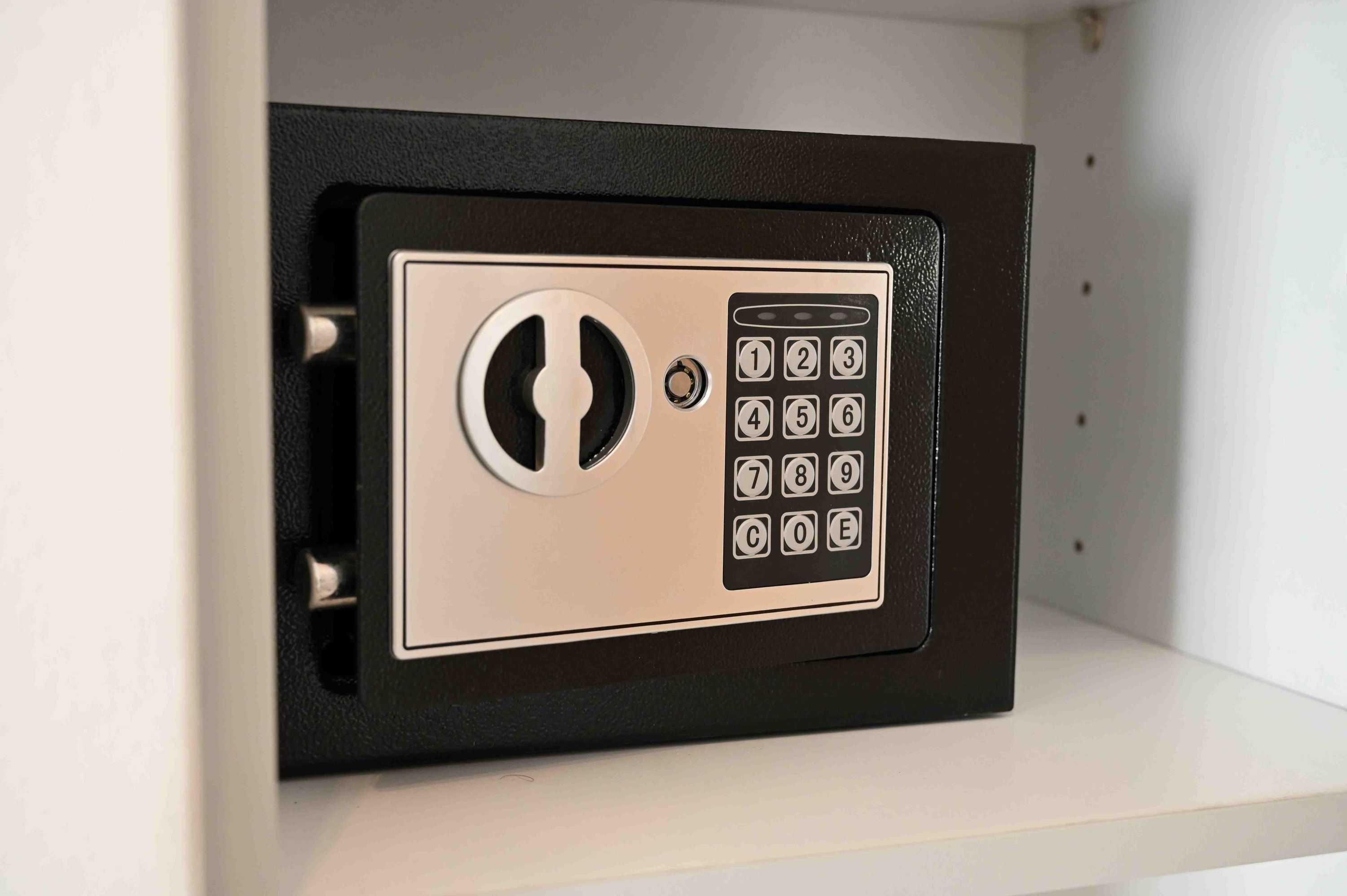 Een zwarte kluis met een numeriek keypad en een sleutelgat.