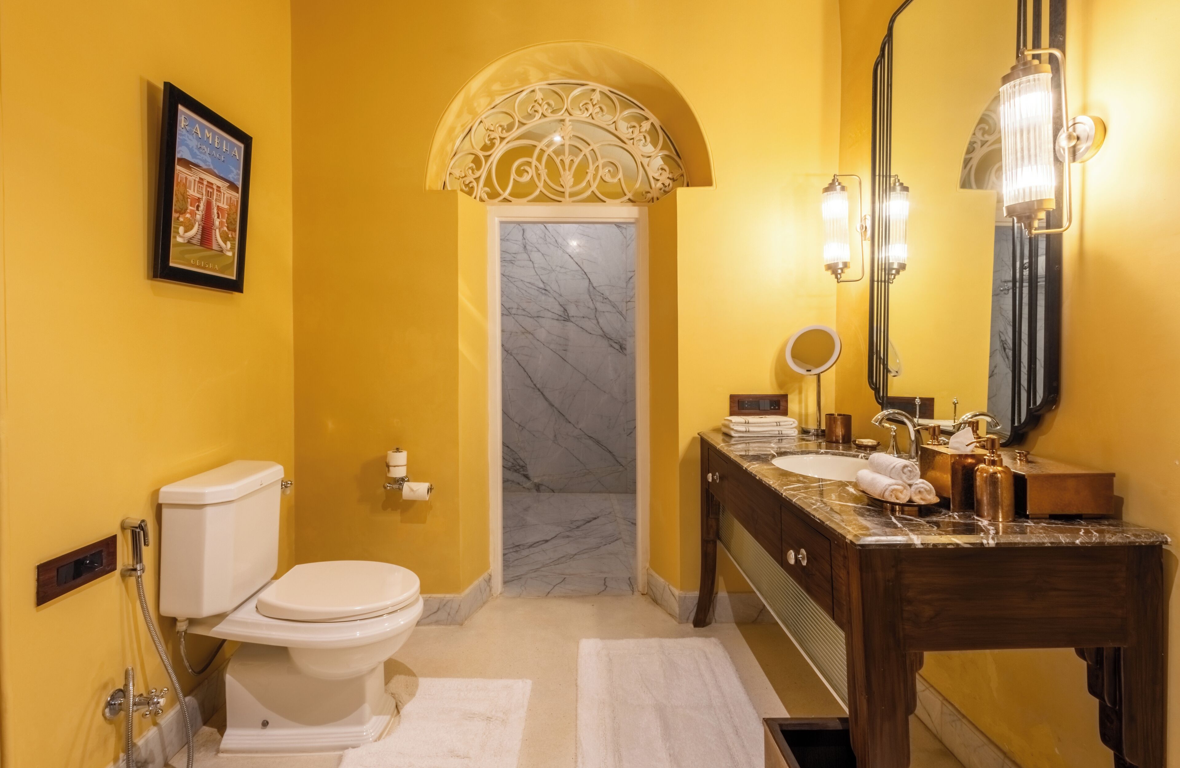 A bathroom with a toilet, sink, and mirror.