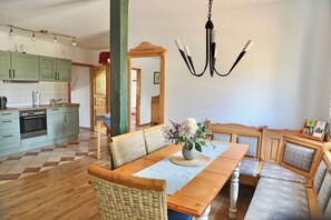 Enjoy casual gatherings in this open-plan living space with a kitchen and dining area.