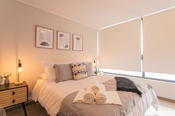 Unwind in this stylish studio with a plush bed and modern decor, offering a serene retreat in the heart of Chile.