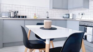 A modern kitchen with a white countertop, grey cabinets, a microwave, a toaster, and a sink. - HushHavenHull-SLEEP 4| Wifi+Netflix| SnookerTable (Kingston upon Hull)