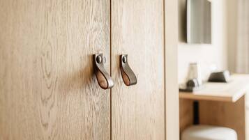 A wooden wardrobe with two metal handles.