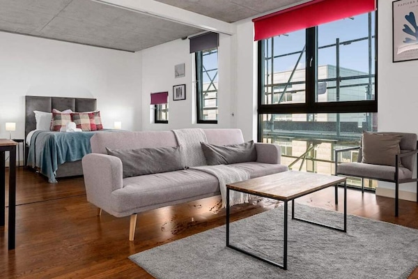 Stretch out in your bright, open-plan living space with canal views flooding in through floor-to-ceiling windows