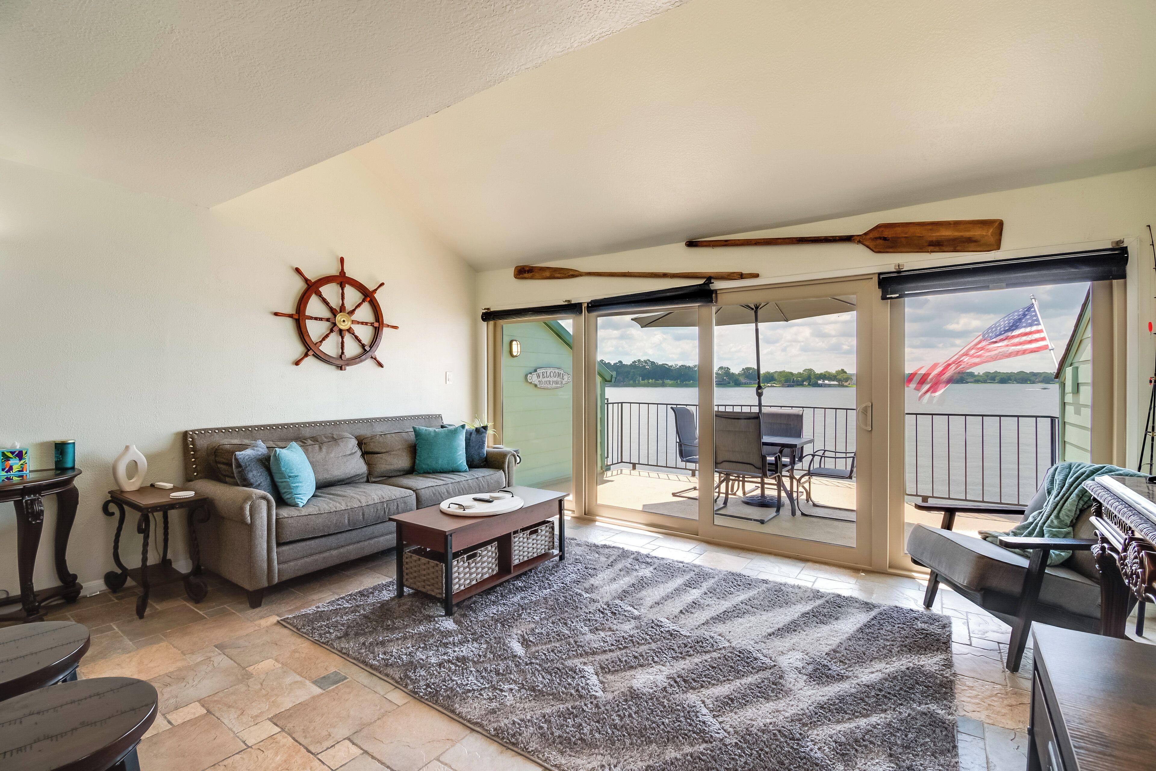 A spacious living room with a sofa, coffee table, and a view of the outdoors.