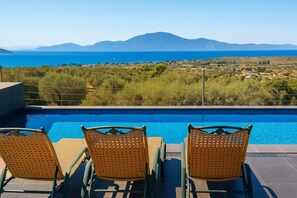 A poolside area with wicker chairs and a view of the sea and mountains. - Evia Private Pool Gem - Seabliss Tranquil Oasis (Politika)