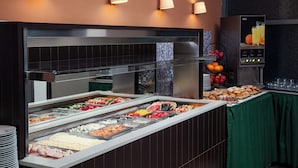 A buffet with various food options, a juice dispenser, and a green tablecloth. - Ankora Hotel Prague (Prague)