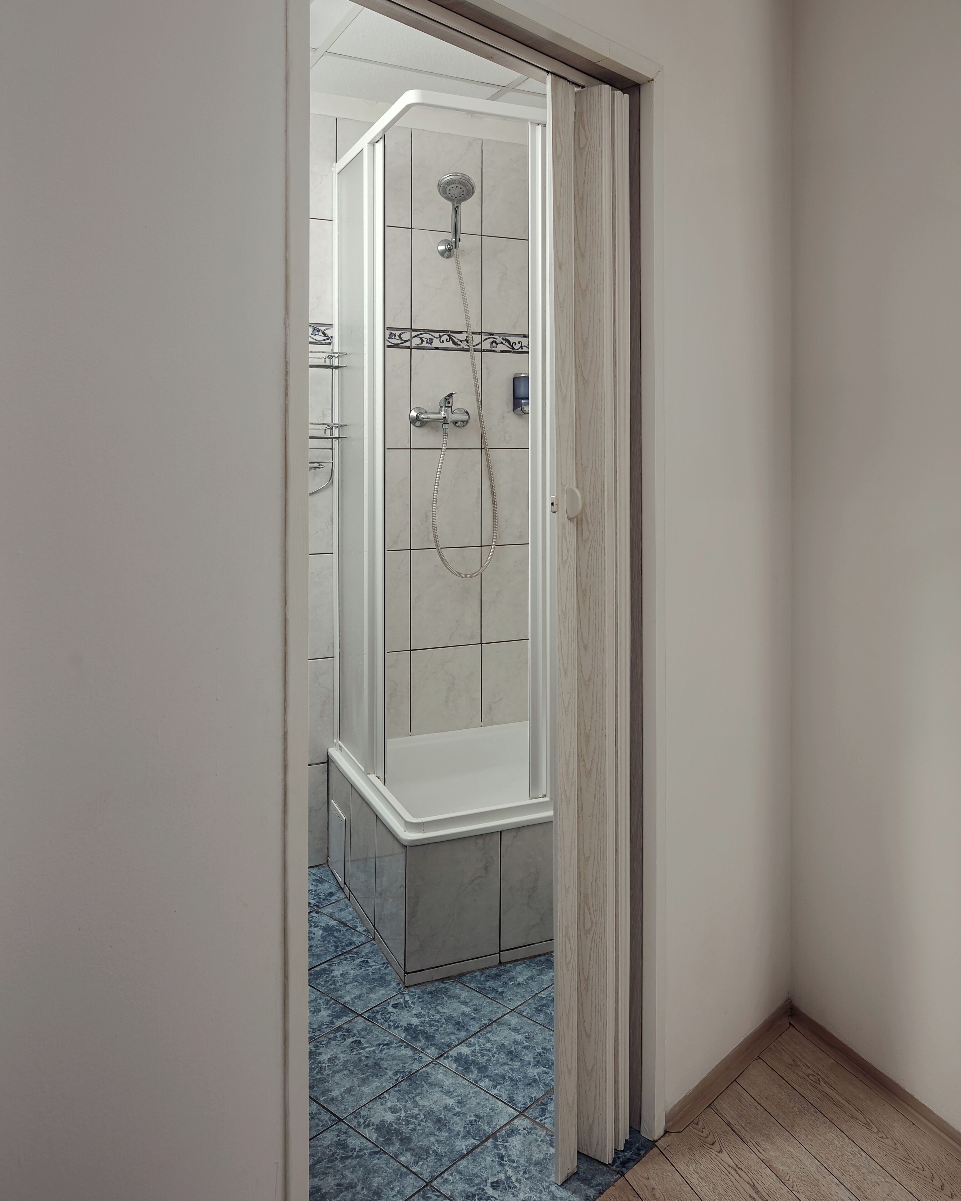 A bathroom with a shower, a toilet, and a sink.