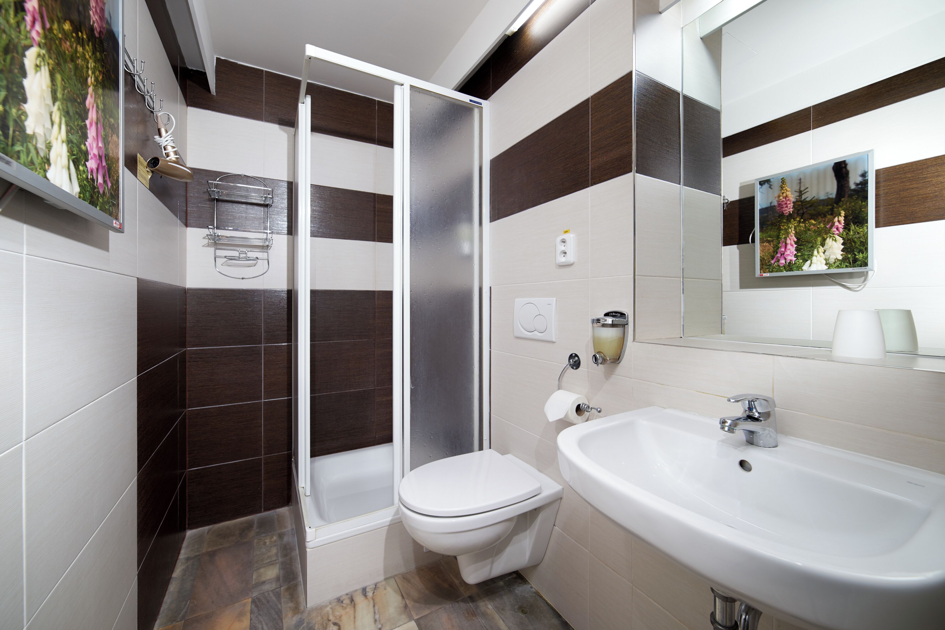 A modern bathroom with a shower, toilet, and sink.