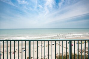 A beach with a view of the ocean and a railing in the foreground. - Gorgeous, Epic Ocean View, & Steps to Beach! Lazy River, Pools, HotTub! (Myrtle Beach)