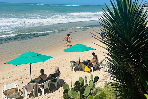On the beach, white sand, sun-loungers, beach umbrellas