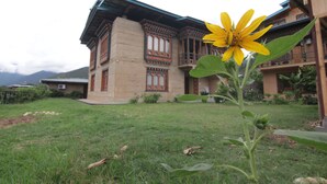A traditional building with a sloped roof and ornate wooden details.