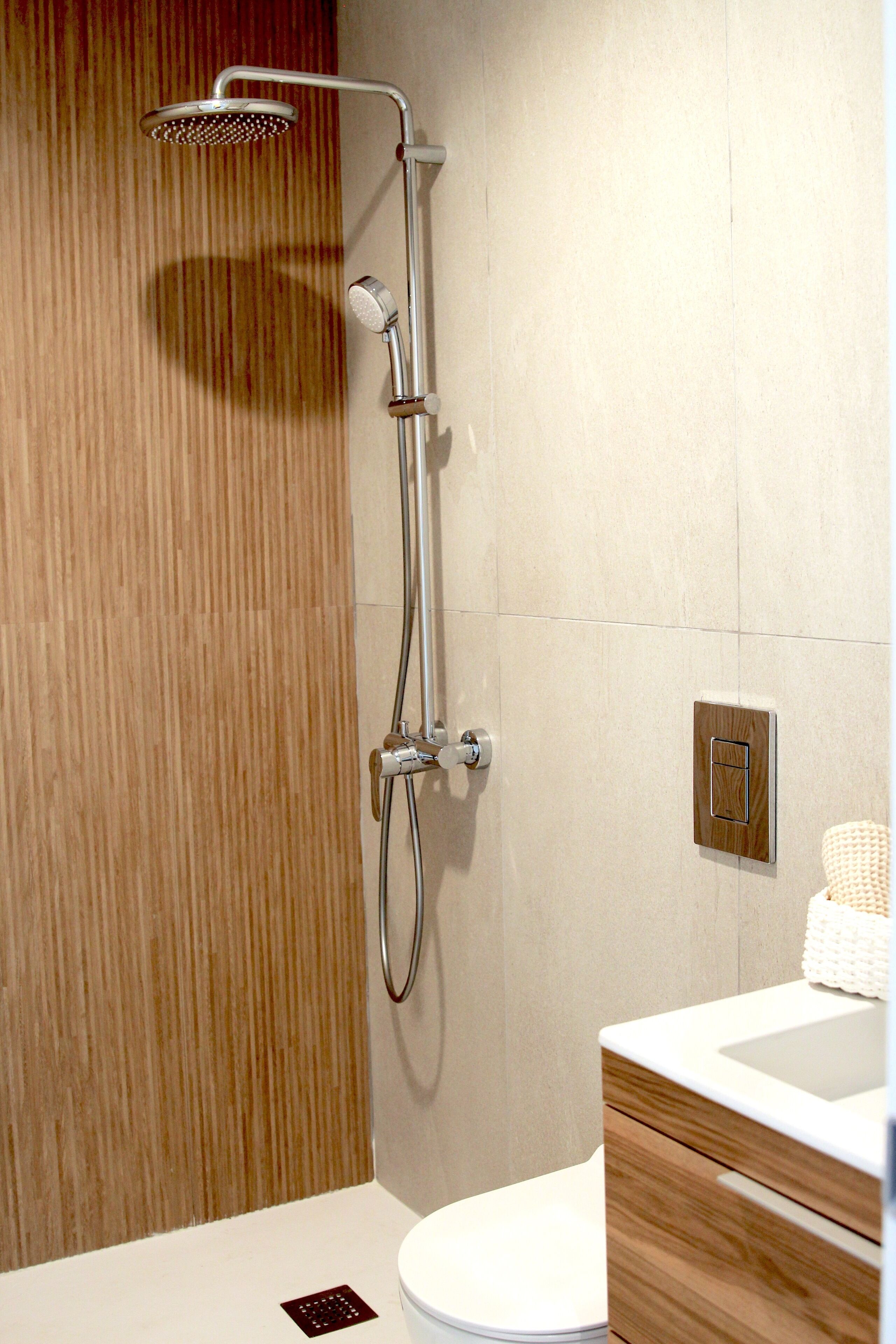 A modern bathroom with a shower, toilet, and vanity.
