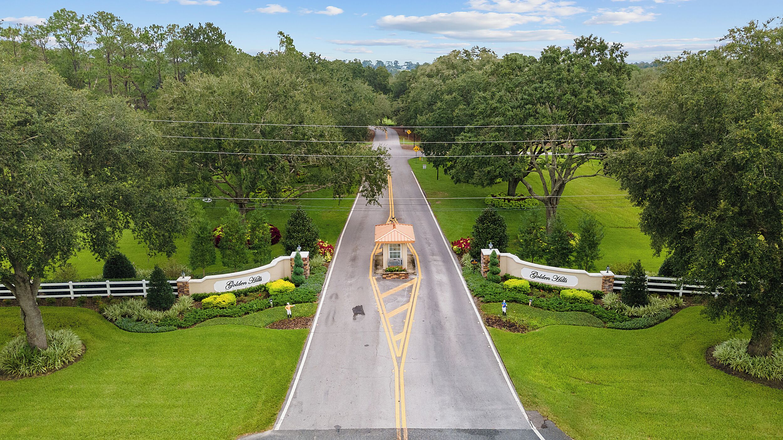 Una strada che conduce a un edificio con un cartello che riporta la scritta "Golden Hills".