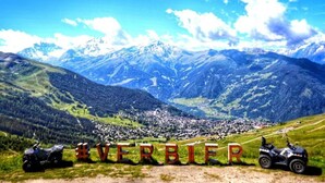 A mountainous landscape with a town in the valley. - 220sqm duplex luxury in the heart of Verbier (Val de Bagnes)