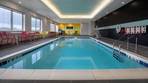 An indoor swimming pool with clear lane markings, adjacent seating areas, and a lifeguard station. - Tru By Hilton Anderson (Anderson)