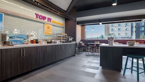 A modern breakfast area with a counter displaying food items and a sign reading "TOP IT BREAKFAST". - Tru By Hilton Anderson (Anderson)