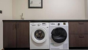 A laundry area with two washing machines and a sink. - 5 bedroom Luxury chalet with panoramic view, nordic bath, high quality finis (Les Gets)