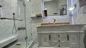 Een douche, handdoeken, zeep, toiletpapier