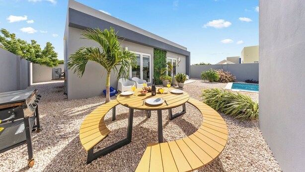 Outdoor dining - 5 min Eagle Beach | New Luxury 1BR w/ Pool & BBQ (Noord)