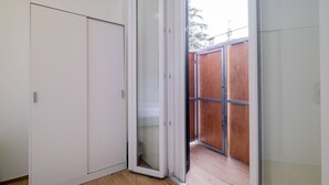 A room with a sliding glass door leading to a wooden deck. - Due Agosto Apartment Comfy Modern and Central (Bologna)