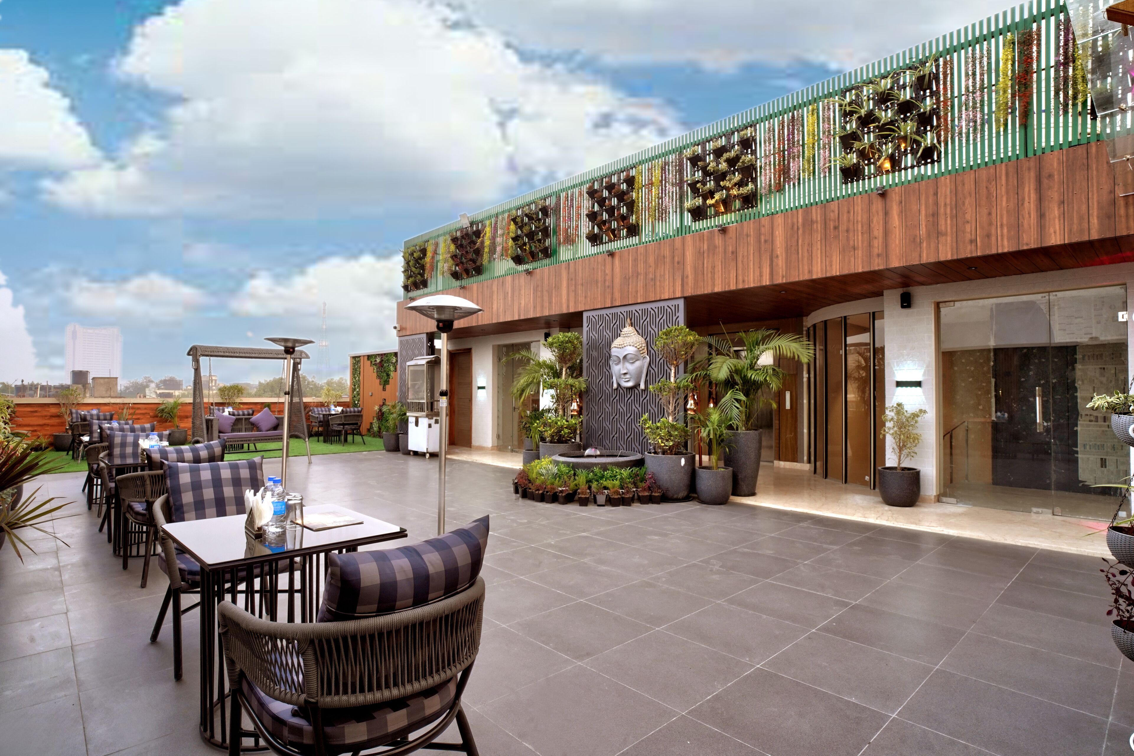 An outdoor patio area with seating and a decorative wall.