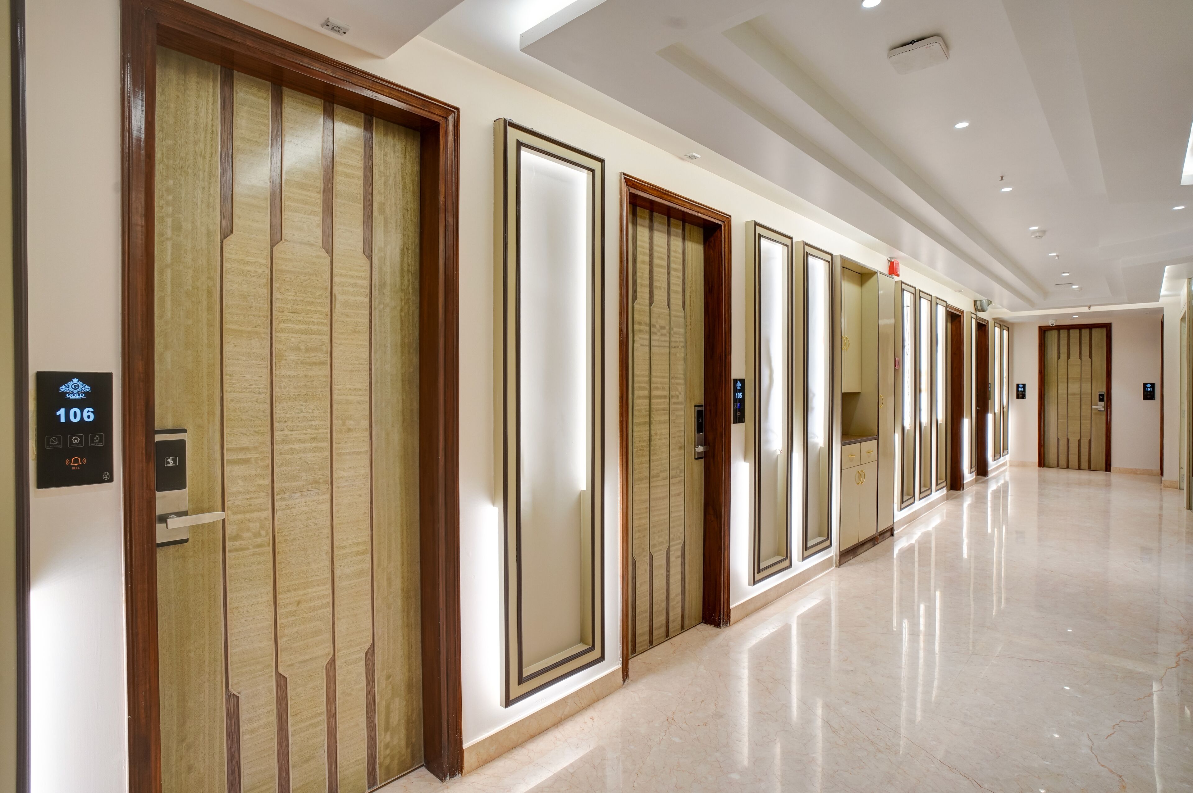 A hallway with multiple elevator doors, each with a digital display showing the number 106.