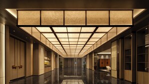 A modern hotel corridor with a reflective floor, recessed lighting, and a grid-patterned ceiling. - Doubletree By Hilton Kaifeng (Kaifeng)