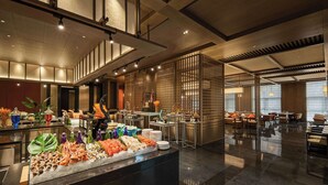 A modern hotel lobby with a buffet area, seating arrangements, and a decorative partition. - Doubletree By Hilton Kaifeng (Kaifeng)