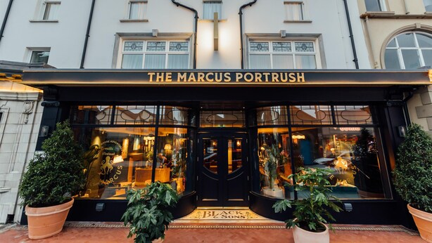 The exterior of The Marcus Portrush hotel with a black facade, large windows, and a prominent entrance. - The Marcus Portrush, Tapestry Collection by Hilton (Portrush)