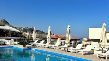 Seasonal outdoor pool, open 8:30 AM to 6:30 PM, pool umbrellas