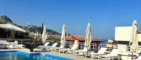 Seasonal outdoor pool, open 8:30 AM to 6:30 PM, pool umbrellas
