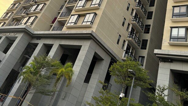 A high-rise building with multiple balconies and a modern architectural design.