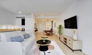Relax in a comfortable living space with a sofa, coffee table, and flat-screen TV.