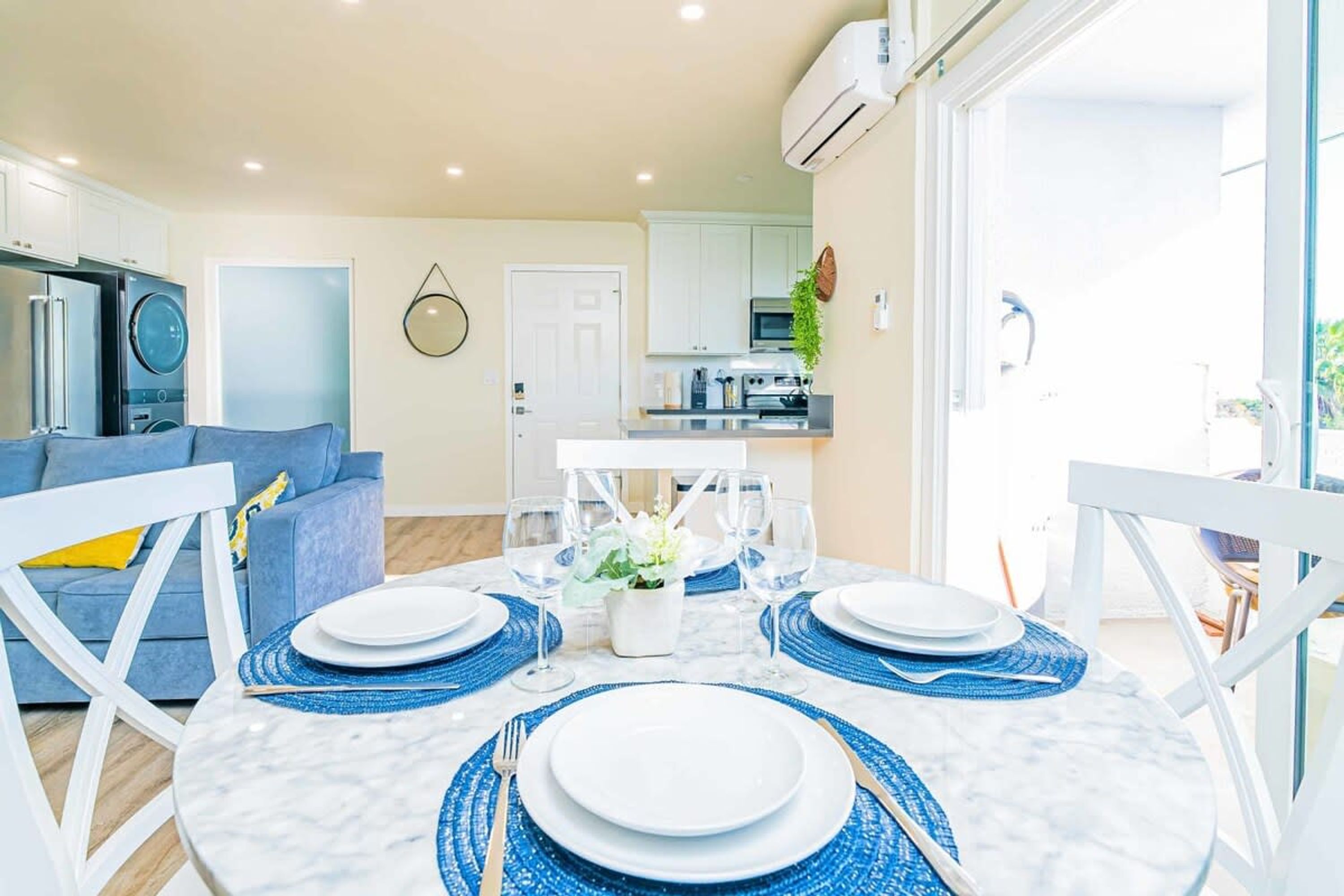 A modern kitchen with white cabinets, a built-in oven, and a microwave.