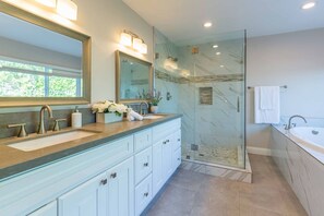 A modern bathroom with a glass-enclosed shower, a large mirror, and a double sink vanity. - Luxury Pool Home in Glendora Foothills Retreat (Glendora)