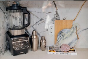 A kitchen with a blender, a cocktail shaker, and a marble countertop. - Cozy Family Retreat Game Room Backyard in Hacienda (Hacienda Heights)