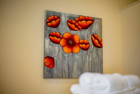 A painting of orange flowers on a textured gray background. - Modern Luxury in San Gabriel Valley Retreat (Glendora)