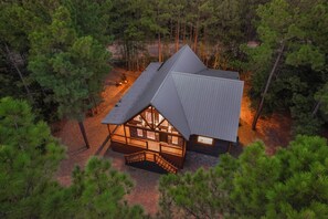 Escape to a secluded forest retreat with a lodge nestled among towering pine trees.